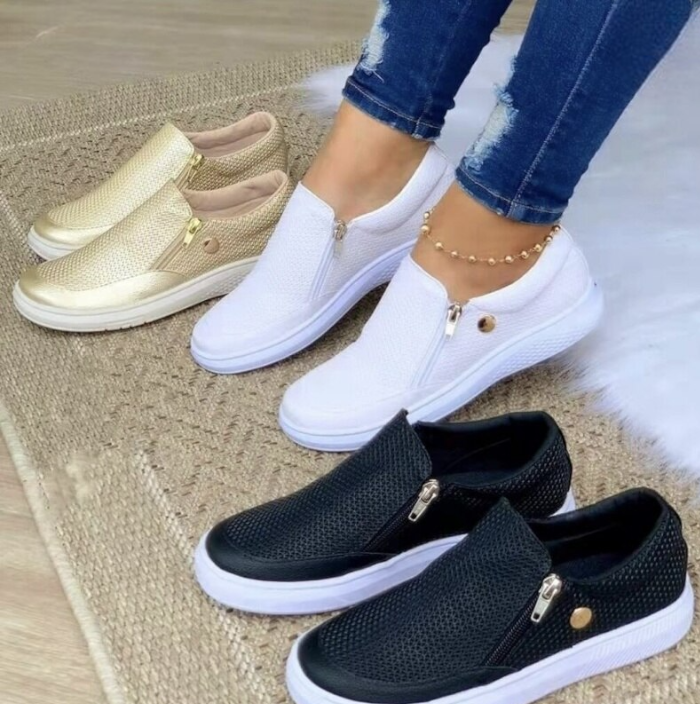 Fashionable women's platform slip-on sneakers with side zip in white, black or gold for trendy style.