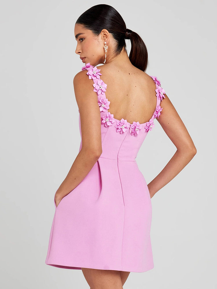 Women's sophisticated mini dress featuring delicate floral embellishments. Perfect for evening events.