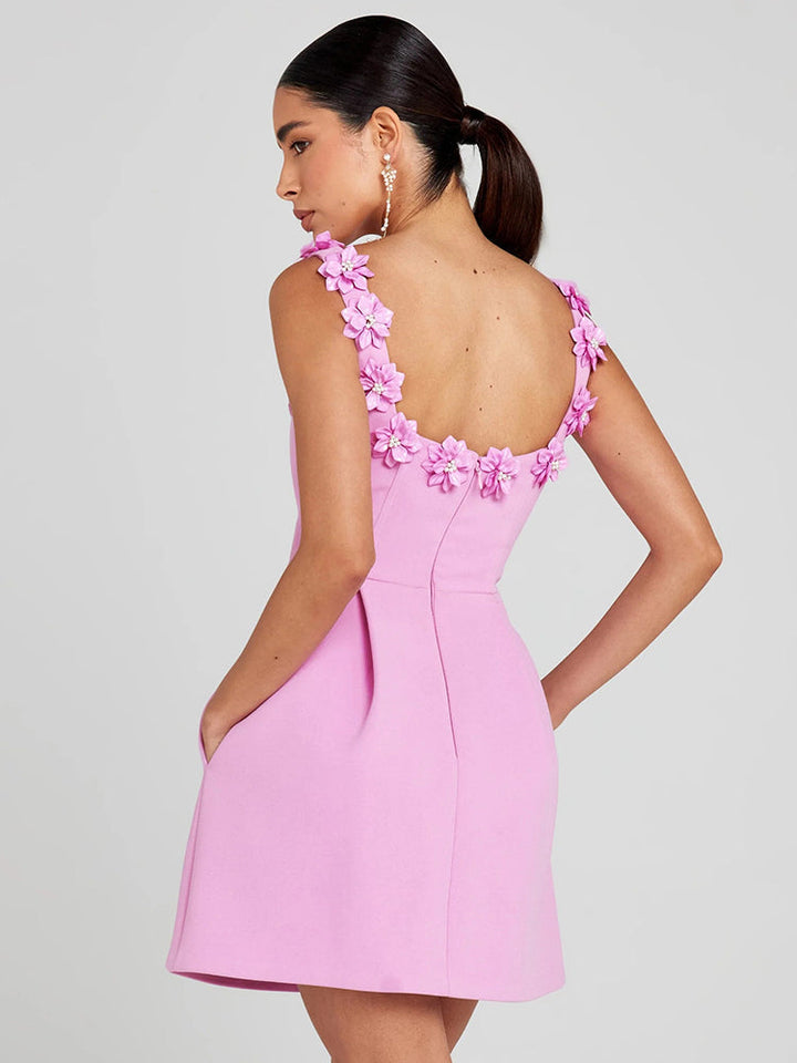 Women's sophisticated mini dress featuring delicate floral embellishments. Perfect for evening events.