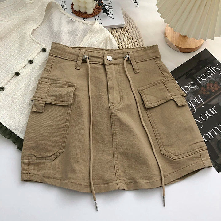 Women's high-waist A-line mini skirt with cargo-style pockets, exuding vintage street style.