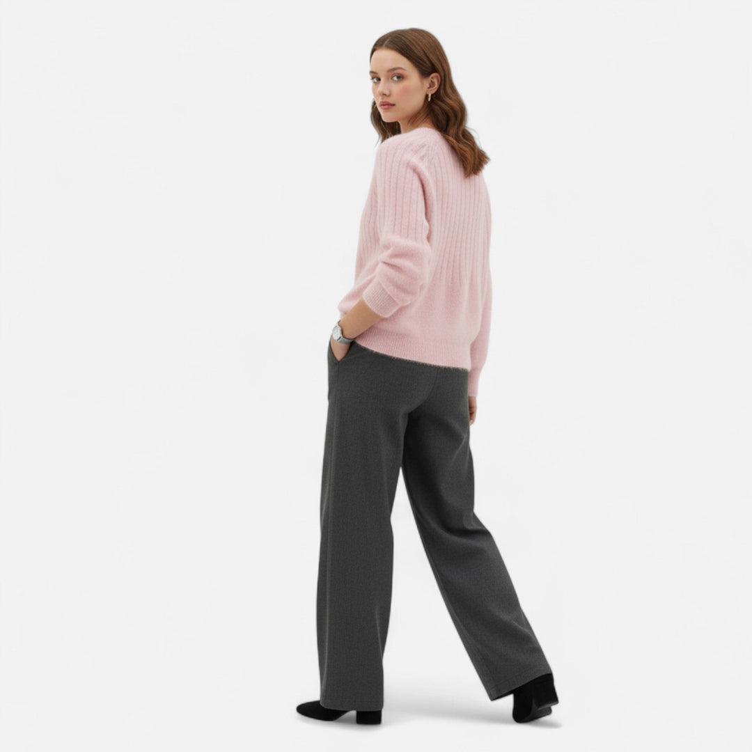 Woman wearing a versatile beige knit sweater, styled casually for everyday comfort and timeless fashion.