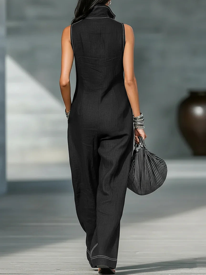 Black sleeveless jumpsuit for women, designed with a prominent chic white trim, offering a modern look.