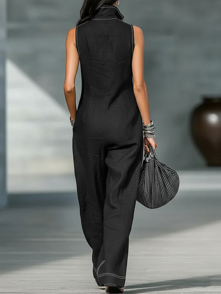 Black sleeveless jumpsuit for women, designed with a prominent chic white trim, offering a modern look.