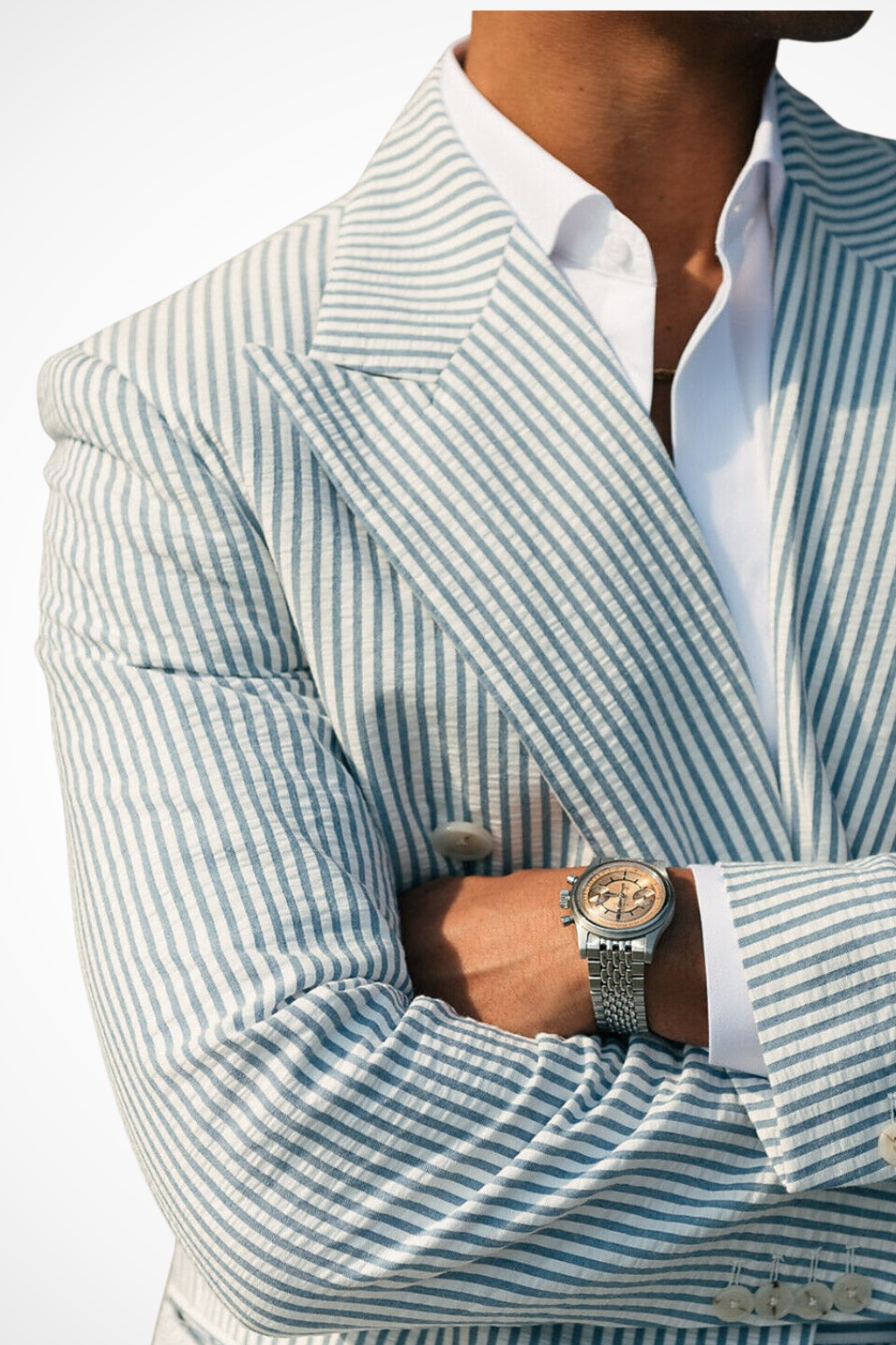 Detail of double-breasted buttons & peak lapel on a men's elegant striped formal occasion suit.