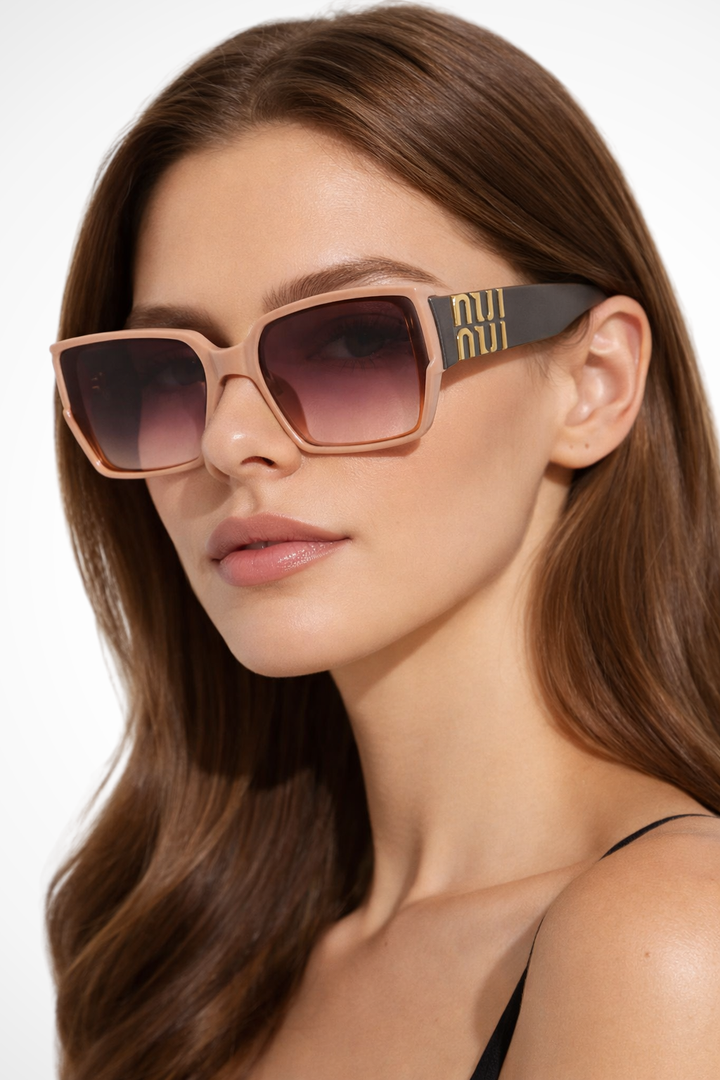 Women's oversized square sunglasses with prominent gold detail. Fashionable eyewear for sun protection.