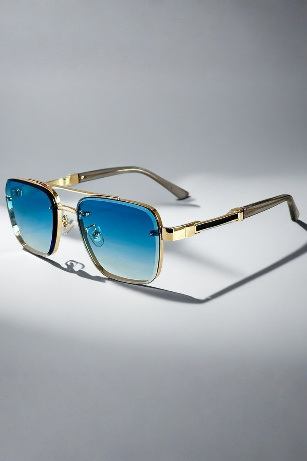 Chic men's aviator square sunglasses. Features a polished gold metal frame & dark gradient lenses.