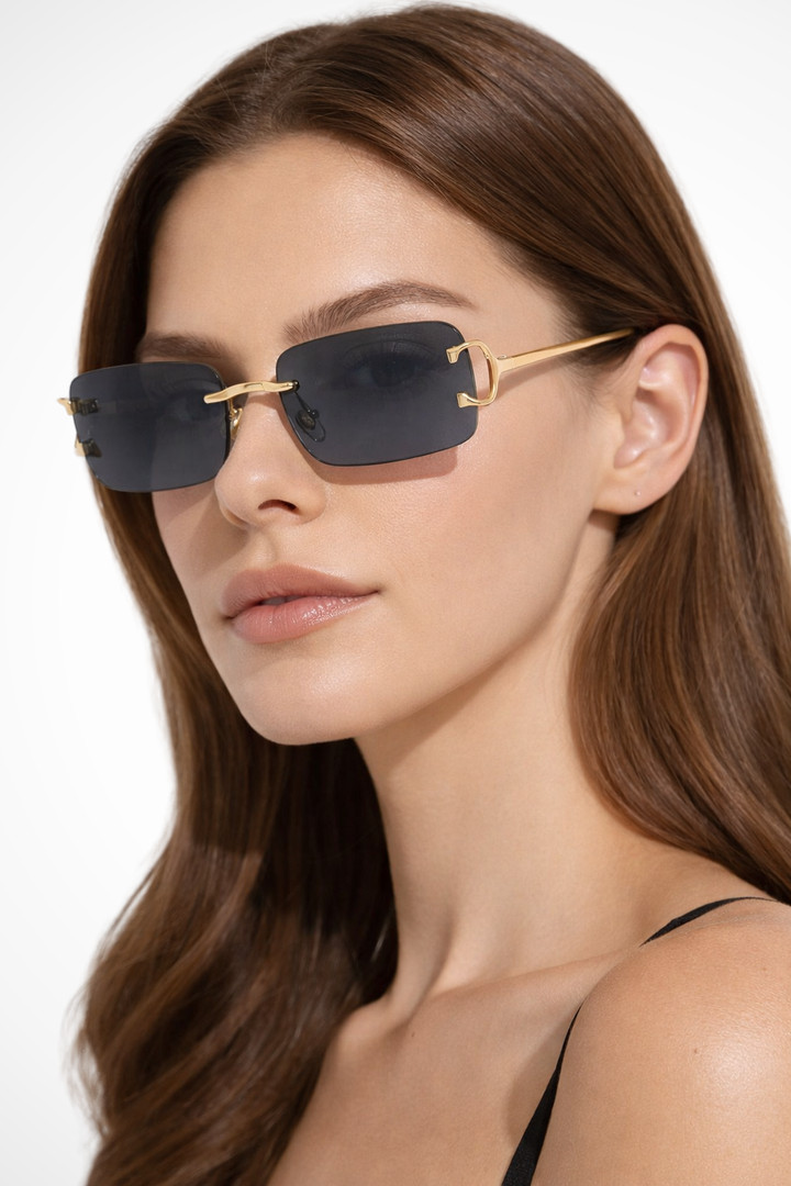 Modern women's rectangle rimless sunglasses with tinted lenses & a luxurious gold frame. Chic fashion eyewear.