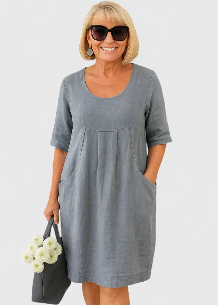 Stylish women's fashion midi dress with half sleeves, scoop neck, and practical pockets. Elegant & versatile.