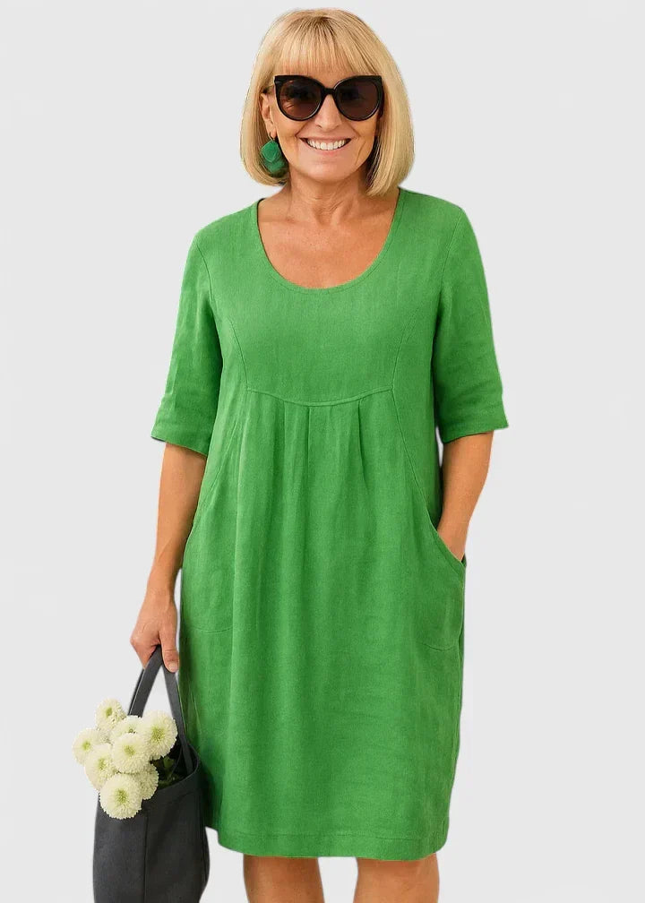 Elegant women's midi dress with pockets, half sleeve, scoop neck. Versatile style for spring/summer fashion.
