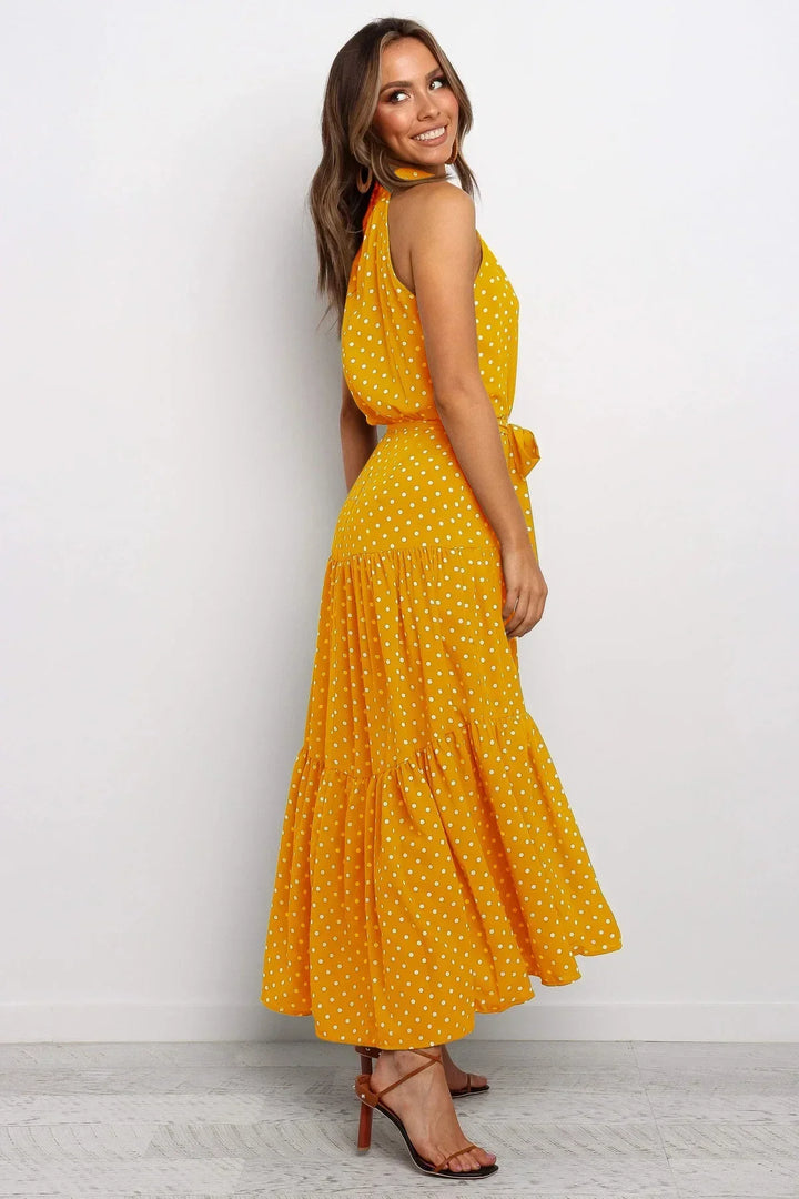 Beach-bound women's polka dot maxi dress, flowy for summer.
