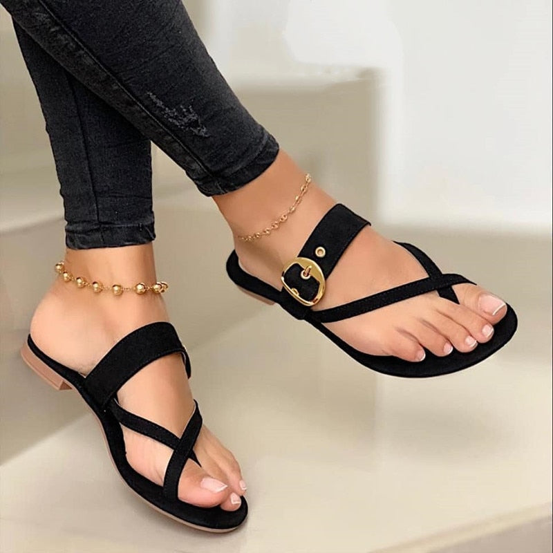 Women's flat strap sandals with stylish buckle detail. Comfortable open-toe summer footwear, perfect for daily casual wear.