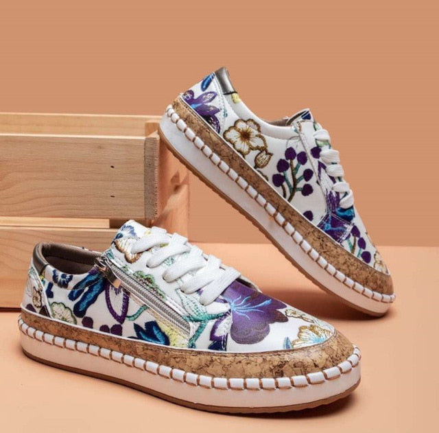 Lightweight women's athletic footwear with supportive orthopedic features and fashionable floral embellishments.