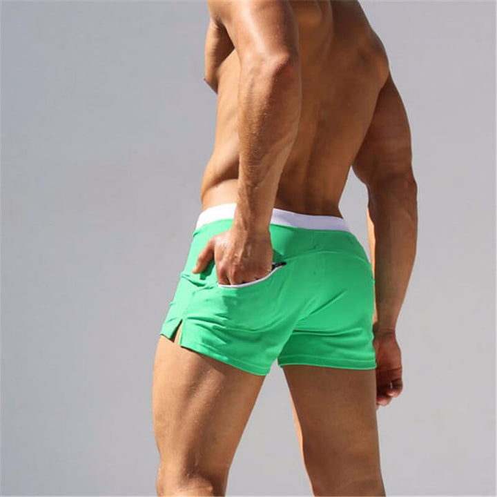 Navy blue men's modern swim shorts featuring a comfort fit waistband for resort wear.