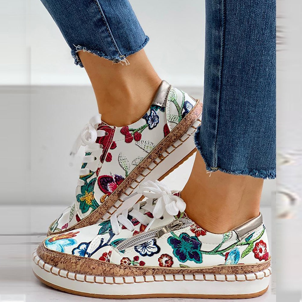 Comfortable women's athletic sneakers featuring a vibrant floral pattern, offering excellent foot support.