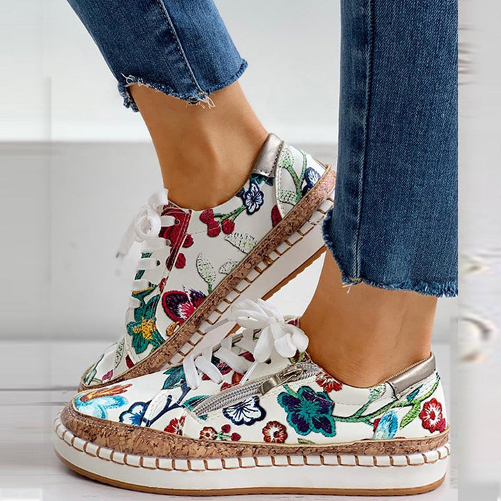 Comfortable women's athletic sneakers featuring a vibrant floral pattern, offering excellent foot support.