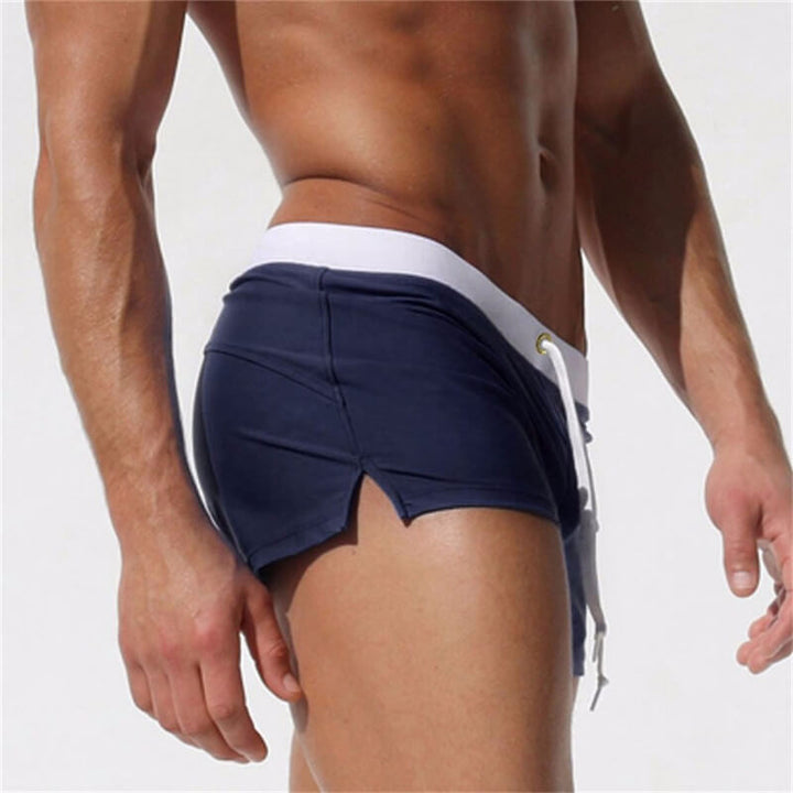 Black men's swim shorts with elastic comfort waistband, quick-dry for stylish pool wear.