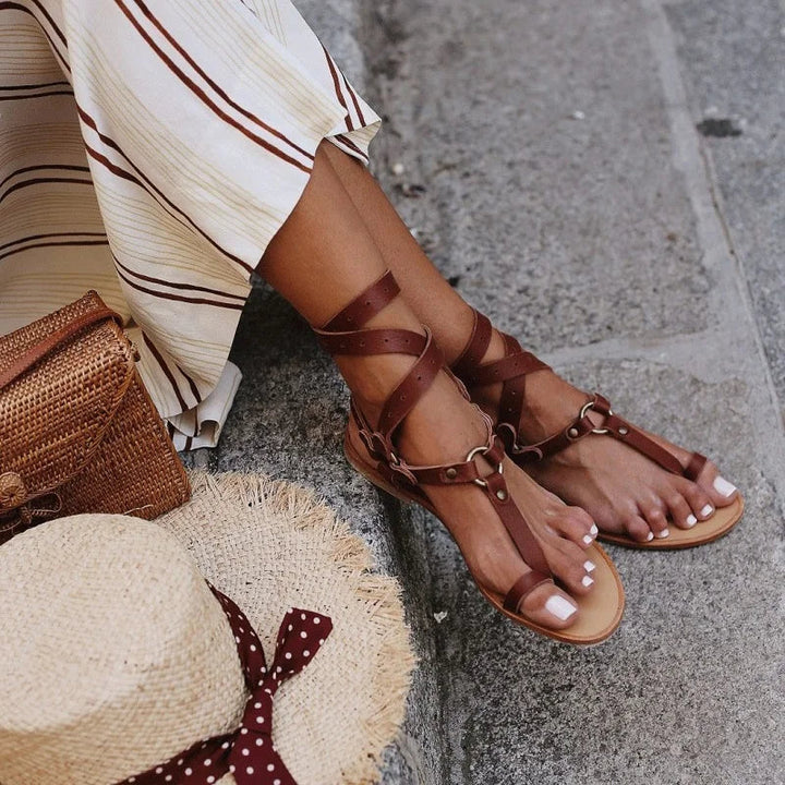 Fashionable women's snake print T-bar gladiator sandals with ankle buckle, ideal for casual summer wear.