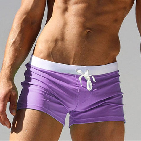 Green men's modern swim shorts, quick-dry fabric & comfort fit elastic waist for summer.