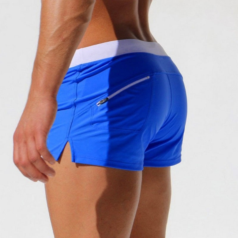 Khaki men's modern swim shorts, quick-dry material & comfort elastic waist for vacation.