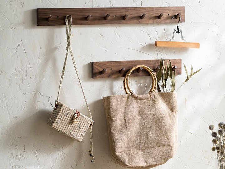 Handmade walnut wood minimalist coat rack, perfect for a modern Japandi entryway organizer.