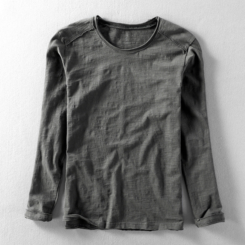 Close-up of the textured fabric on a men's long sleeve crew neck casual shirt.