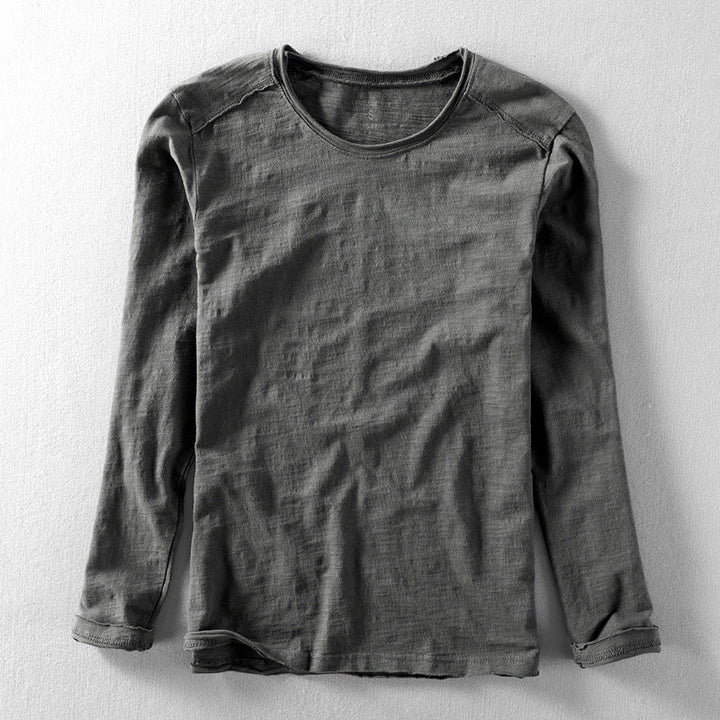 Close-up of the textured fabric on a men's long sleeve crew neck casual shirt.