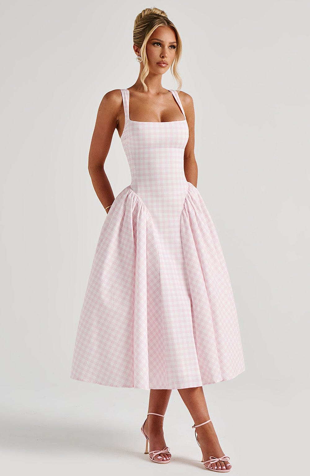 Feminine gingham midi dress, square neck & sleeveless, features an elegant drop waist & full skirt for a flattering look.