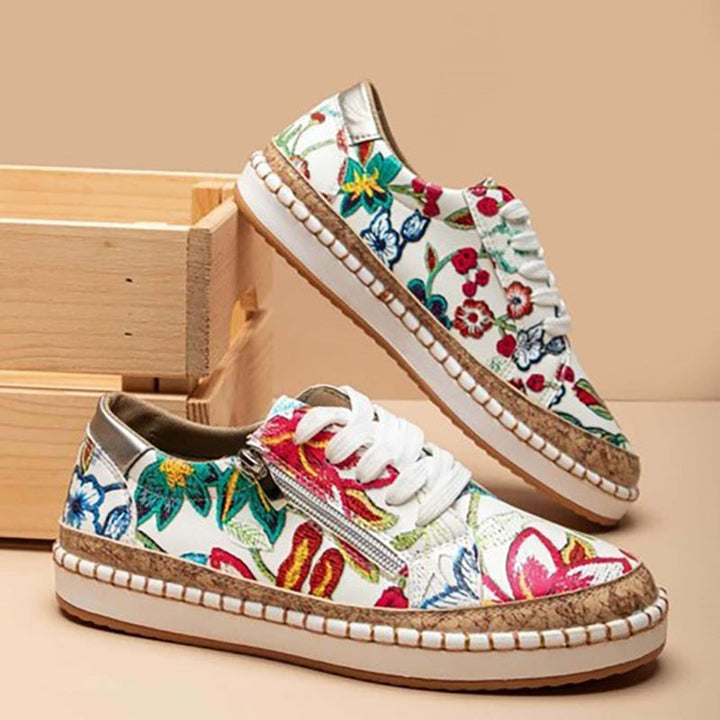 Side view: Women's comfortable sports shoes with arch support and elegant floral print, great for casual walking.