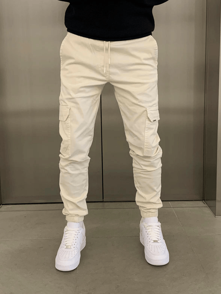Utility cargo trousers for men with a sleek drawstring tie-waist. Relaxed fit, ideal for casual wear.