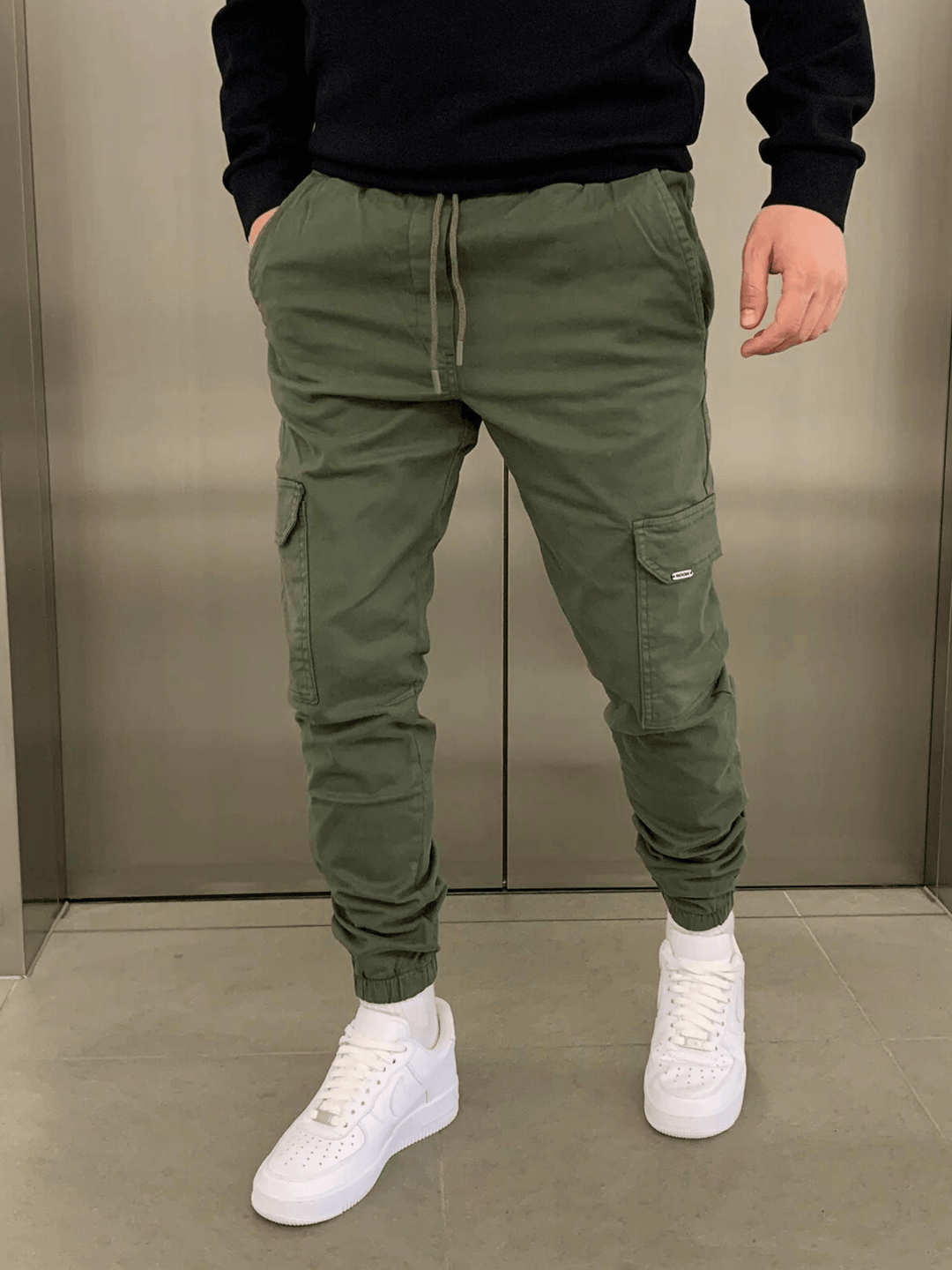 Sleek men's cargo pants with a comfortable tie-waist. Relaxed fit utility trousers for casual fashion.