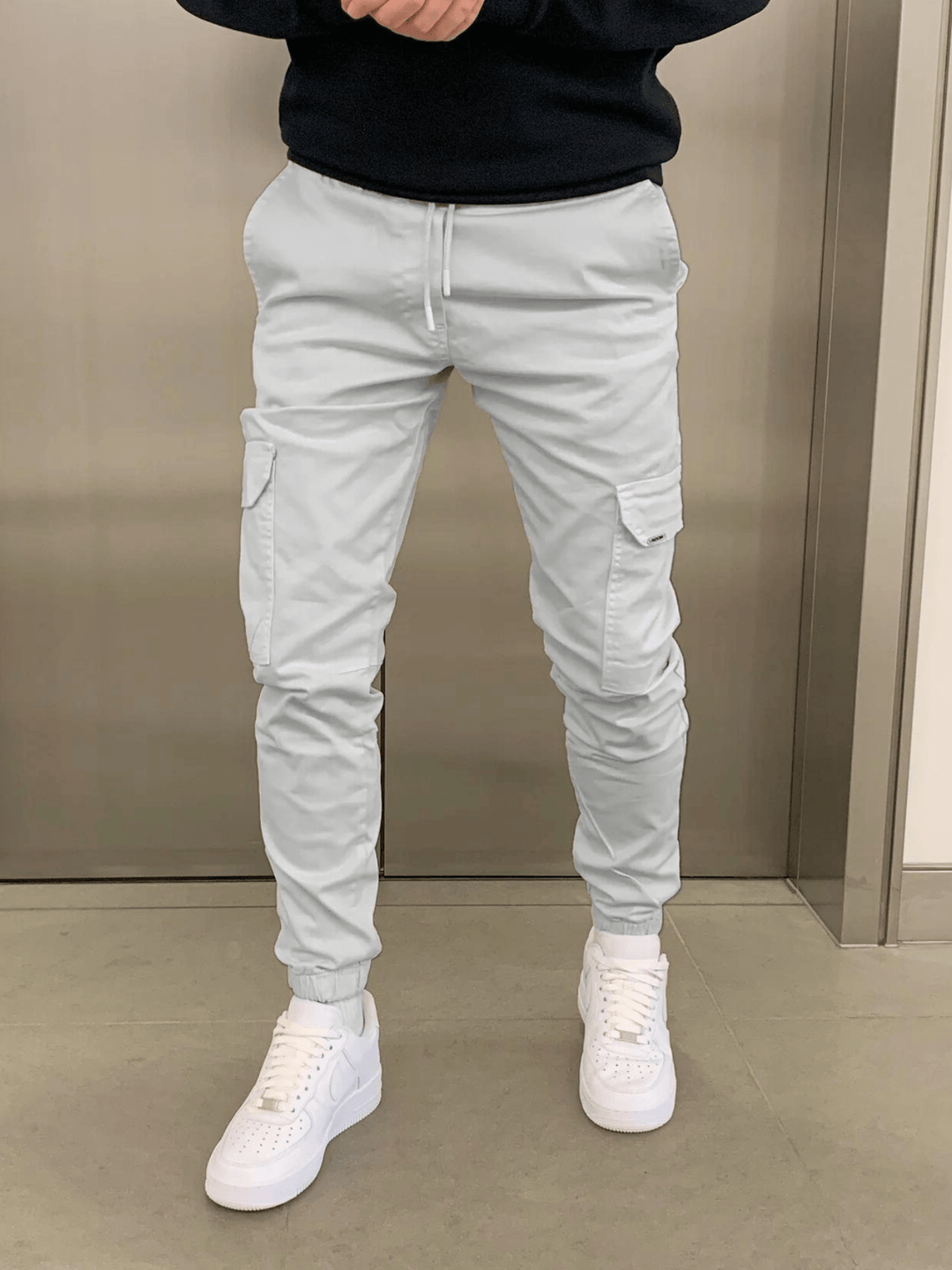 Relaxed fit men's cargo jogger pants with sleek tie-waist. Comfortable & stylish for casual fashion.