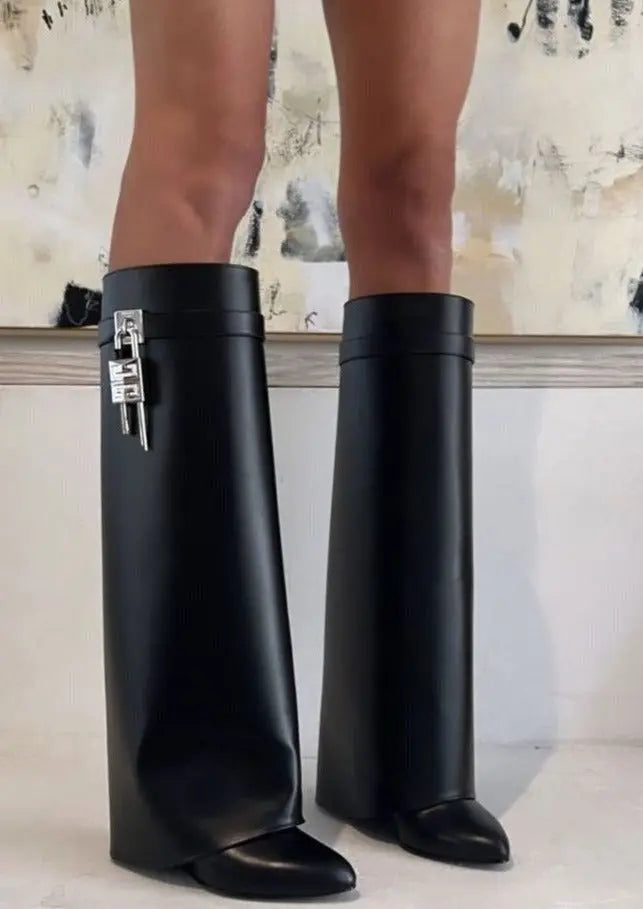 Avant-garde glossy women's wedge boots, tall and sculptural, making a unique fashion statement.