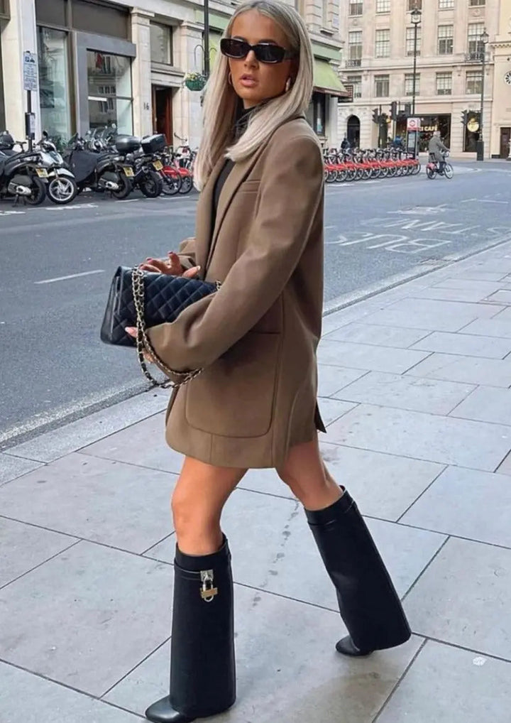 Bold sculptural wedge women's tall boots, glossy black for an edgy street style aesthetic.