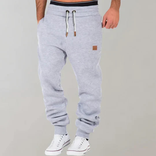 Comfortable men's athletic joggers with an elastic waist and drawstring, perfect for activewear and casual use.