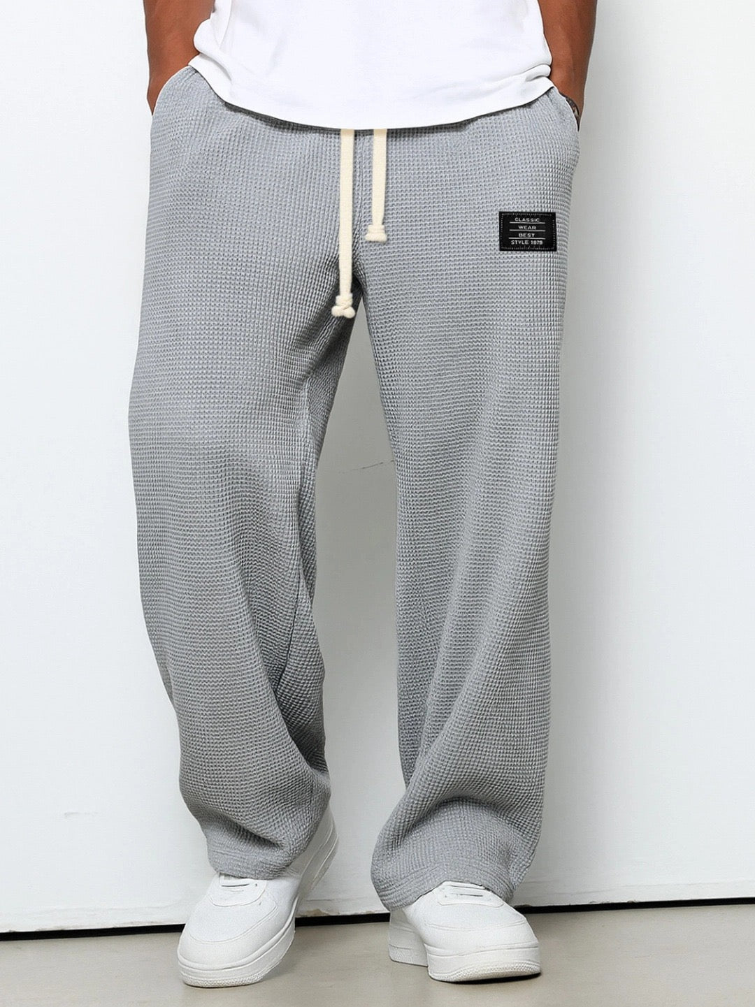 Stylish man in classic men's straight fit trousers & smart casual shirt; comfortable for everyday fashion.