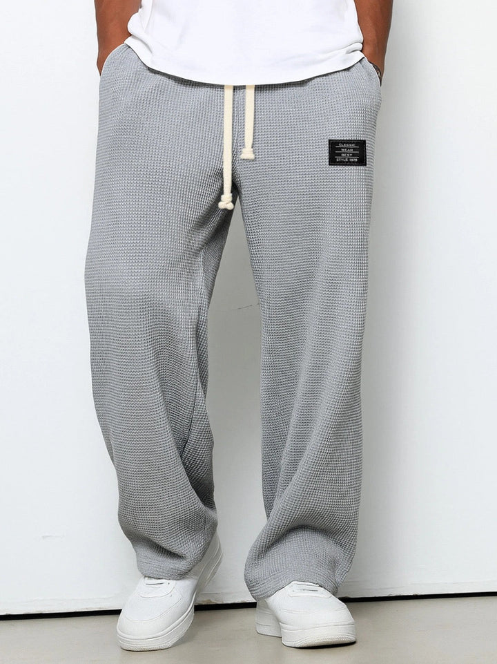 Stylish man in classic men's straight fit trousers & smart casual shirt; comfortable for everyday fashion.