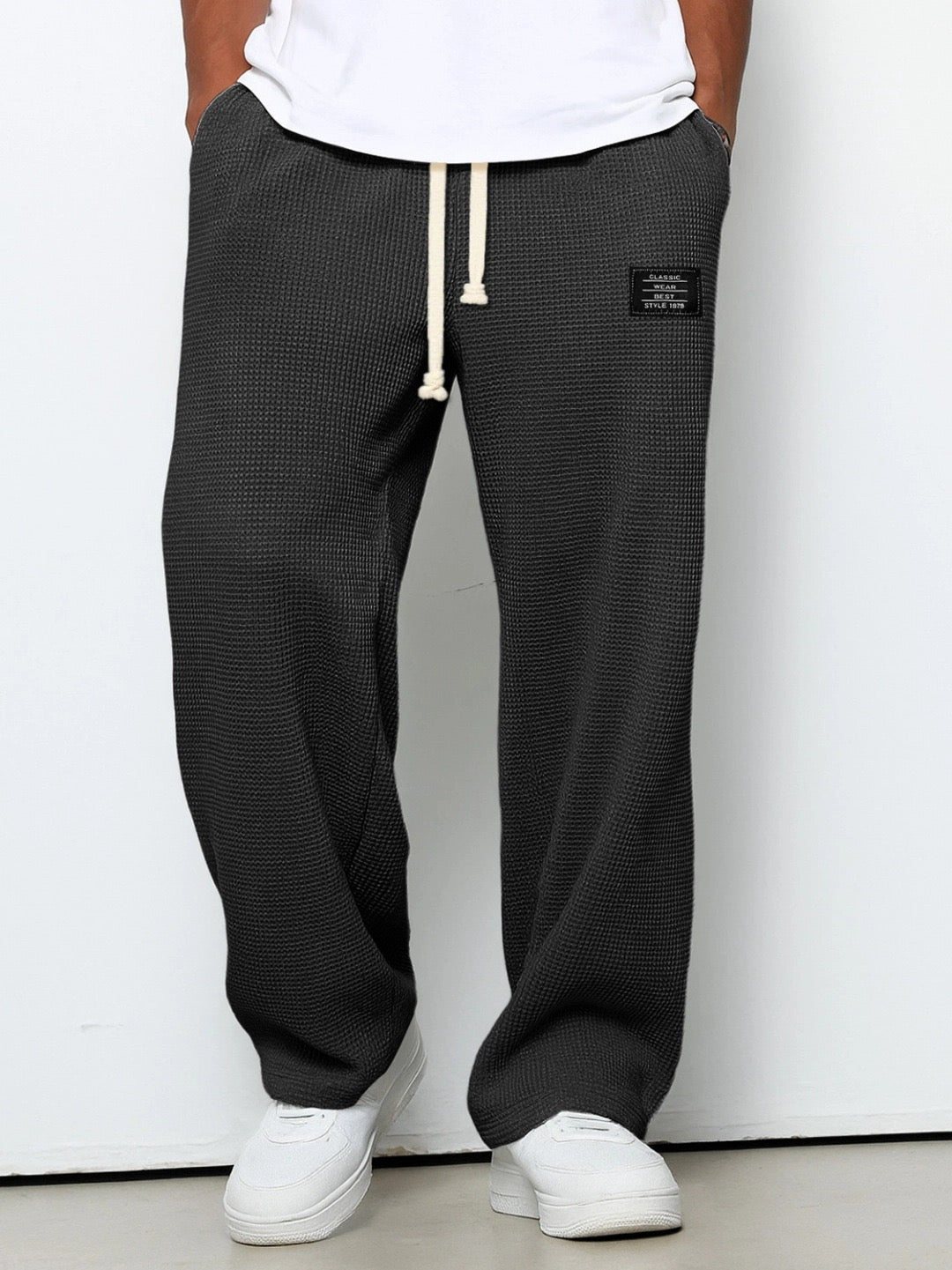 Side profile of men's relaxed fit straight trousers on model, demonstrating comfortable men's everyday fashion.