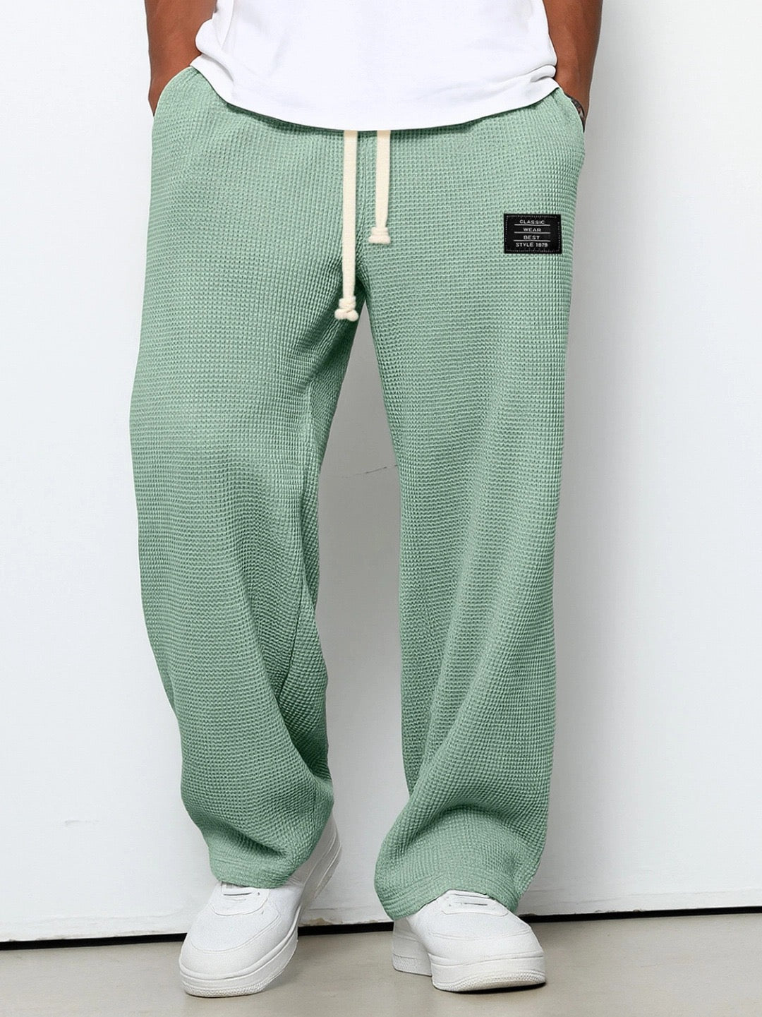 Neatly folded pair of men's relaxed fit everyday trousers, showcasing their classic versatile design.