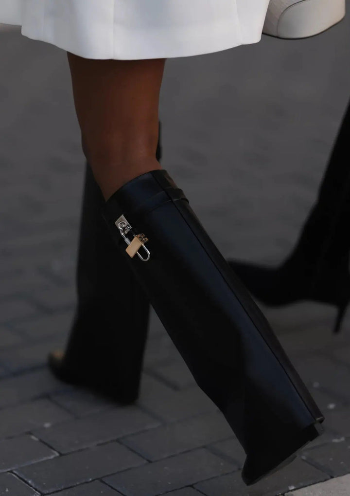 Women's modern elegant knee-high boots, glossy finish with a striking sculptural wedge.