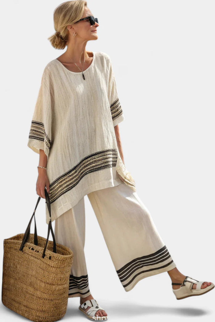 Fashionable women's striped two-piece set, including a chic top and comfortable wide-leg pants for a complete look.