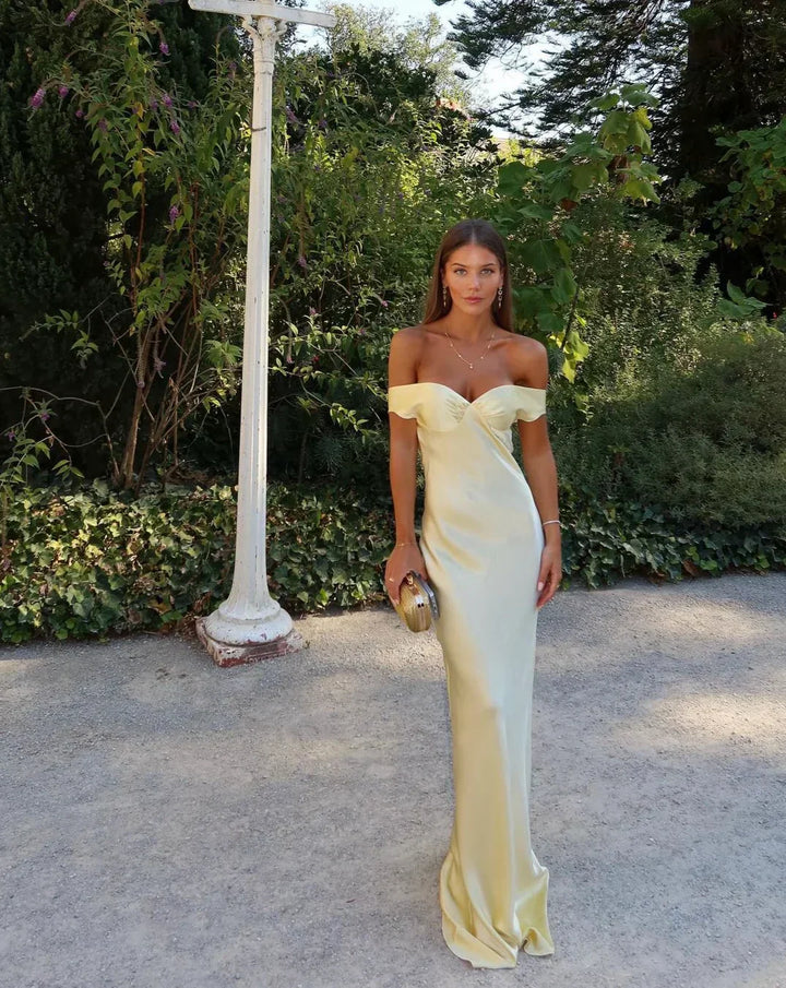 Glamorous women's yellow backless maxi dress, an elegant long gown for formal evening wear and special events.