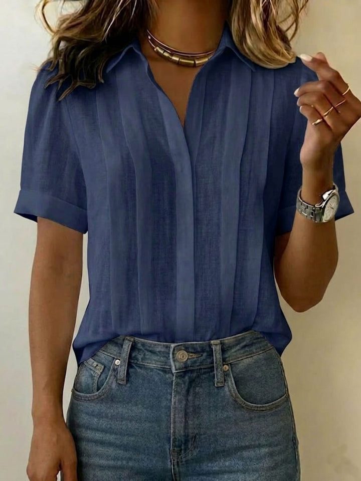 Classic women's short-sleeve blouse with pleated front. Perfect for versatile casual elegant summer outfits.