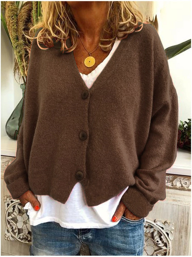 Woman wearing a chic V-neck button-front long sleeve cardigan, showcasing style.