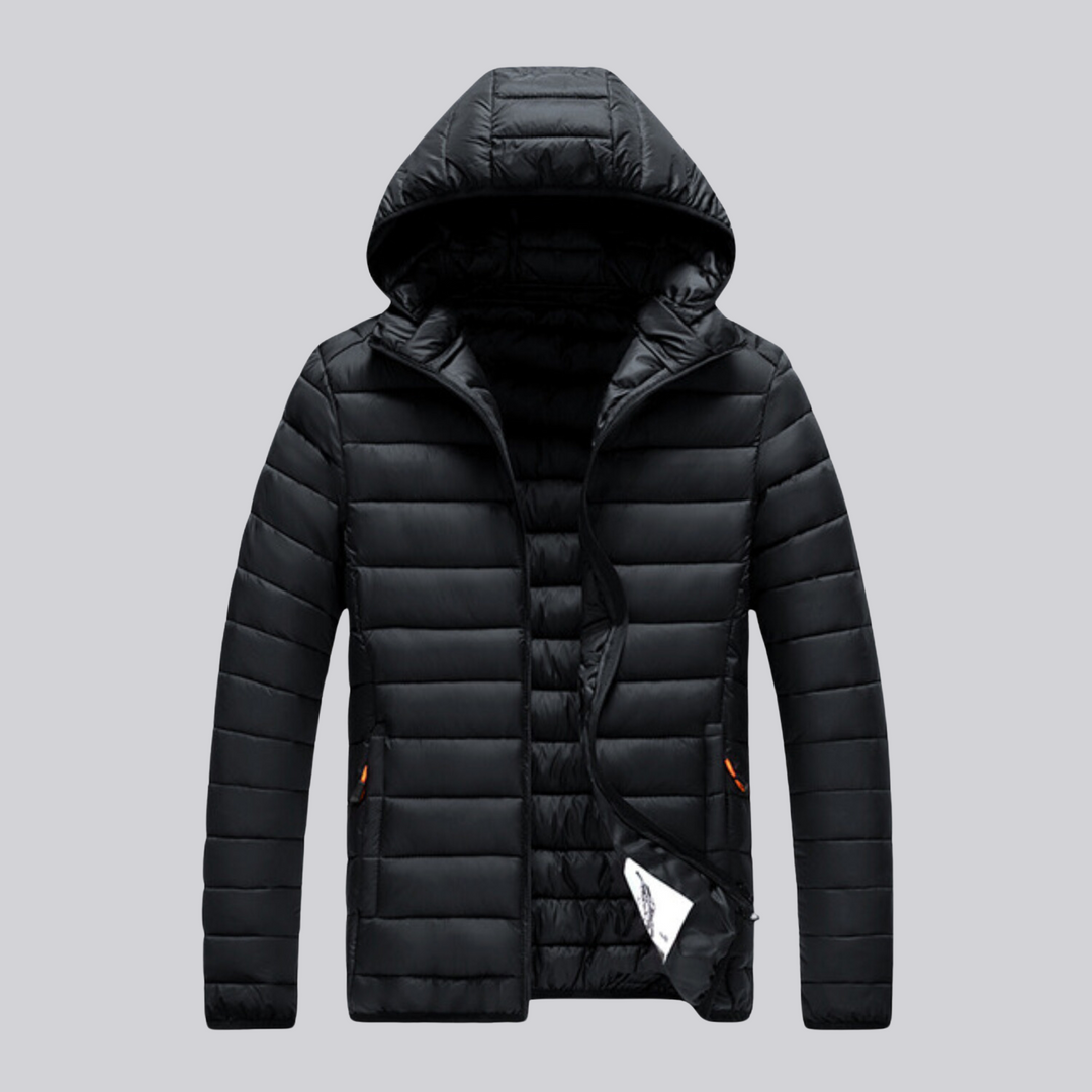 Man hiking in a rugged men's outdoor puffer jacket, providing warmth & protection for winter trails.
