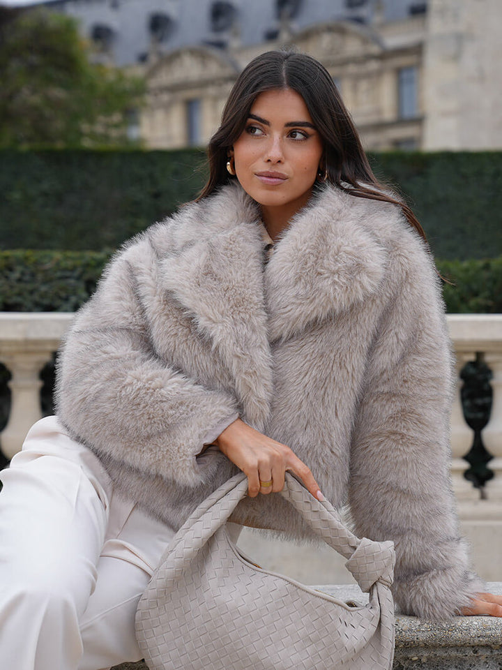 Elegant women's winter jacket with wide lapels. Classic style outerwear for sophisticated warmth.