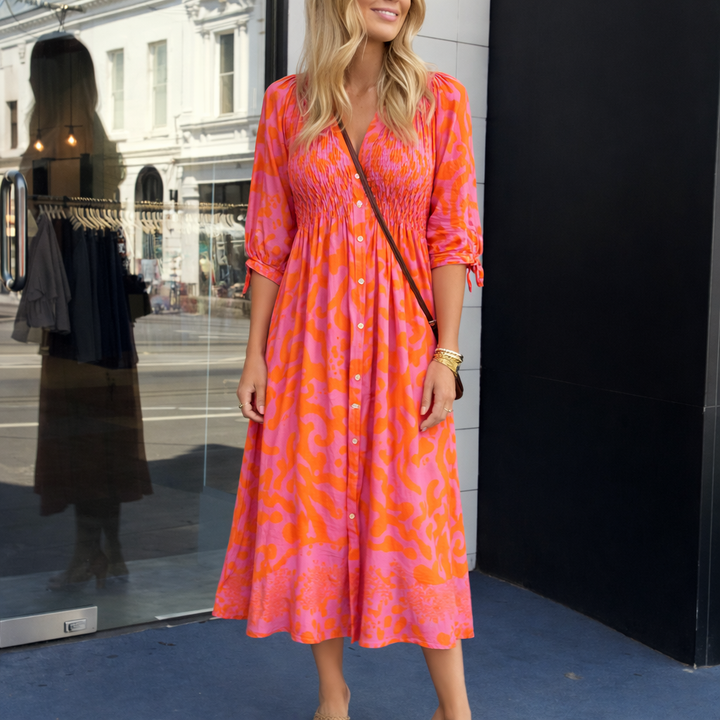 Vibrant orange midi dress for women, ideal for spring & summer. A versatile, sophisticated day-to-night look.