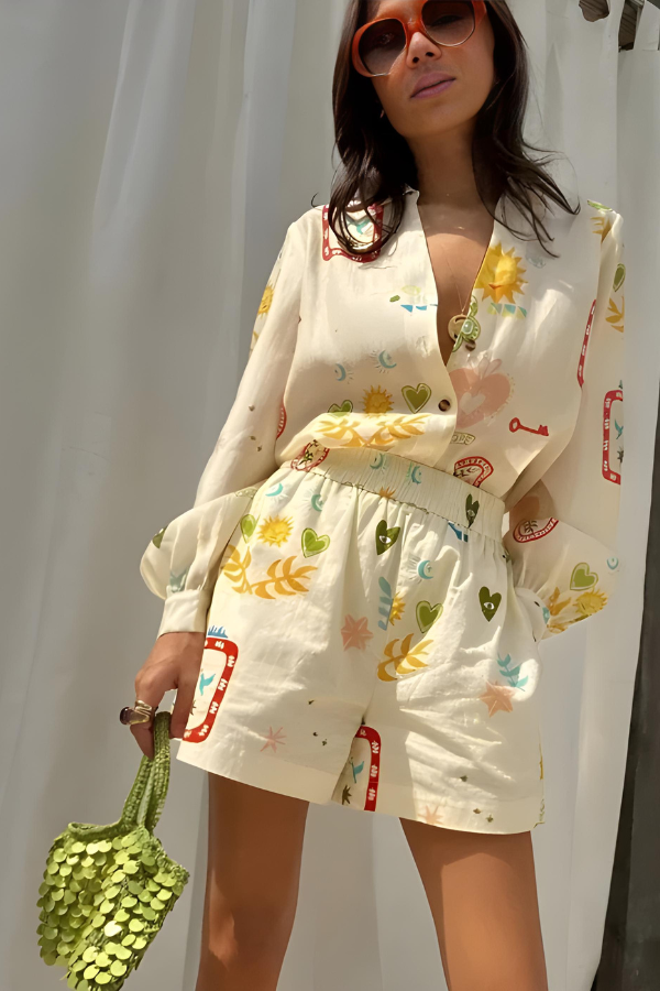 Women's two-piece long sleeve shirt and high-waisted shorts set in a vibrant, eclectic print, ideal for summer.