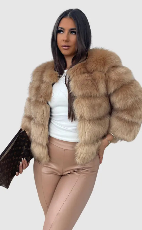Close-up of luxurious fabric on this women's elegant winter coat. Cozy texture for winter.