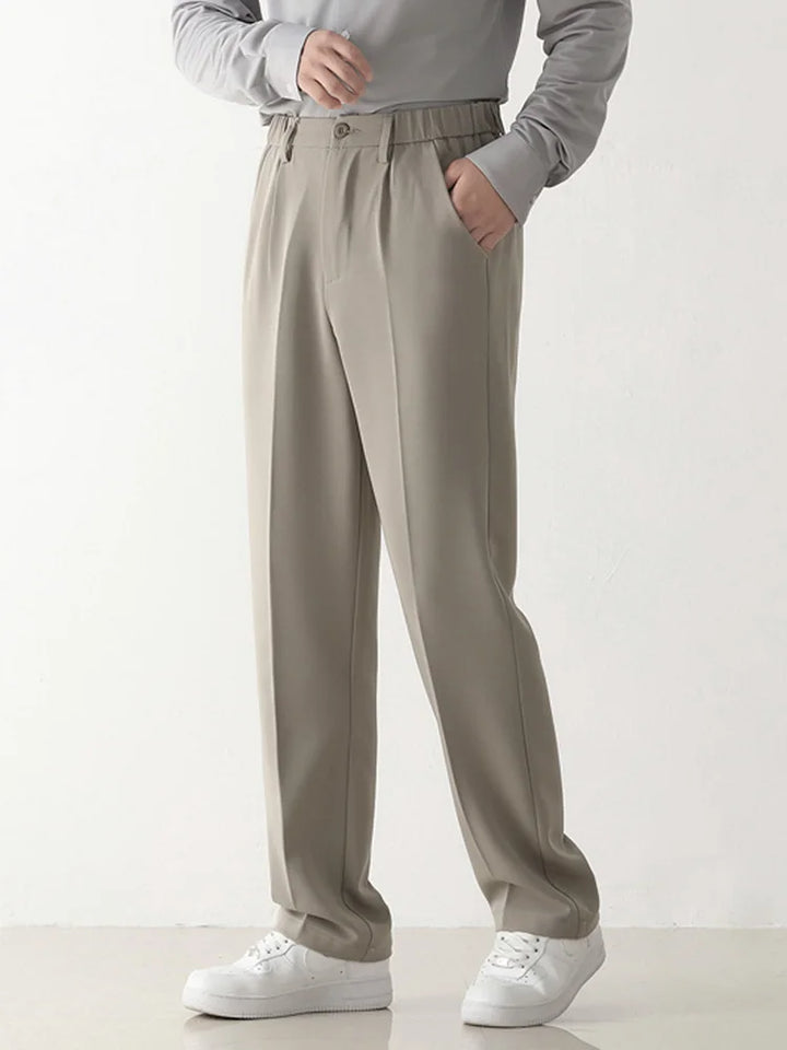 Men's black polyester blend chinos, relaxed fit, ideal for business attire or comfortable casual style.