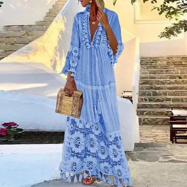 Women's elegant boho maxi dress with intricate lace details and playful tassels, perfect for summer vacation.